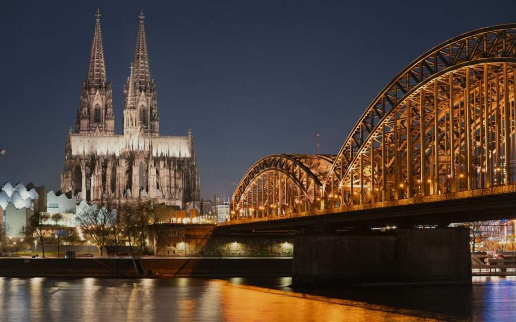 Cologne Cathedral and the Hohenzollern Bridge illuminated at night
