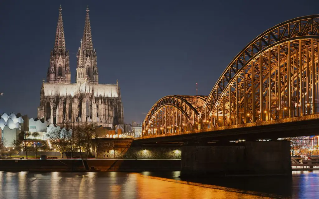 Cologne Cathedral and the Hohenzollern Bridge illuminated at night