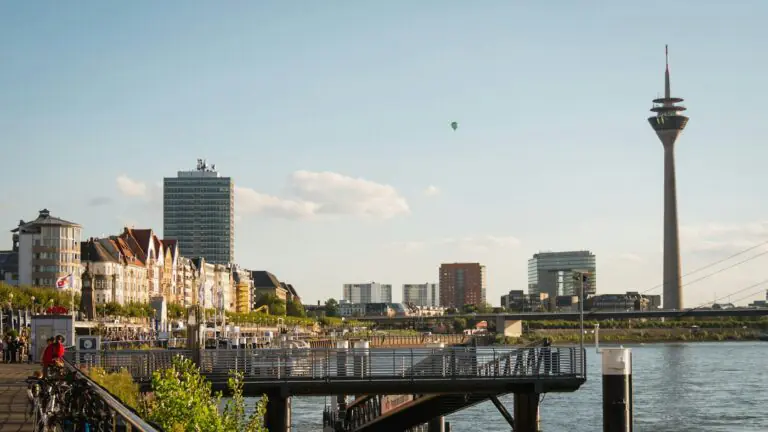 The Rhine promenade in Düsseldorf with the Rheinturm tower downstream