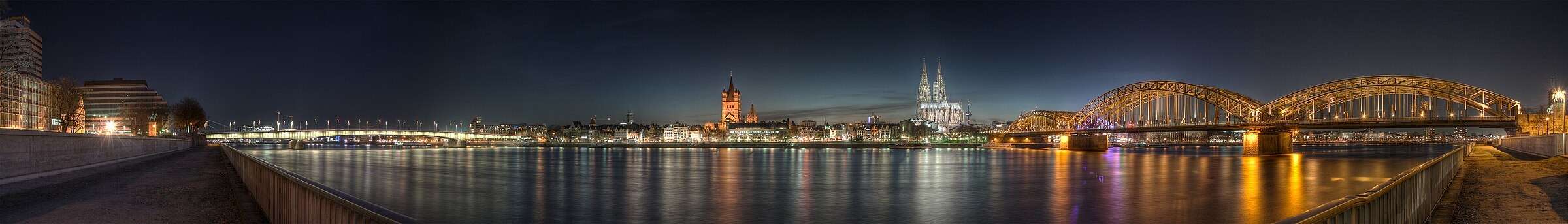 Cologne's old town across the Rhine at dusk, with the cathedral and the Hohenzollern Bridge